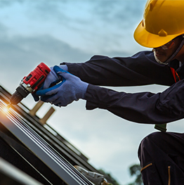 Roofer fastening metal roofing panels
